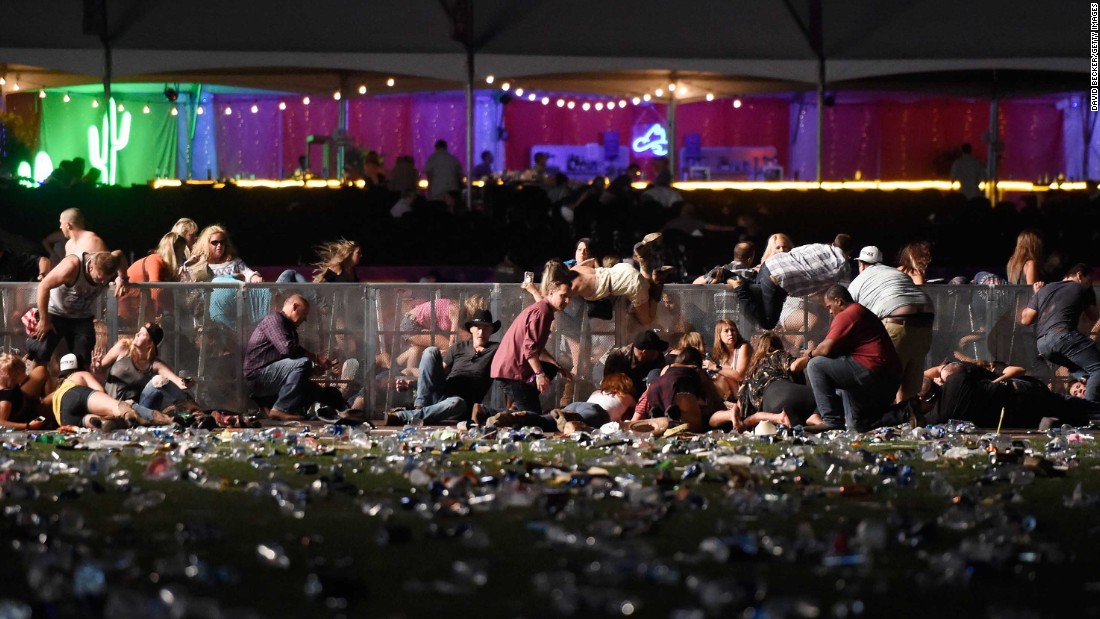 Concertgoers dive over a fence to take cover from gunfire during the Route 91 Harvest Festival in Las Vegas on Sunday, October 1. Dozens are confirmed dead and hundreds injured in the &lt;a href=&quot;http://us.cnn.com/2017/10/02/us/las-vegas-shooter/index.html&quot; target=&quot;_blank&quot;&gt;deadliest mass shooting in modern US history&lt;/a&gt;.