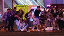 Victims of the shooting are tended to in the street.