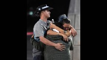 People embrace outside the Thomas &amp; Mack Center after the shooting.