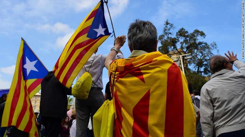 People wave Catalan pro-independence &quot;Estelada&quot; flags in Barcelona, on October 2, 2017.