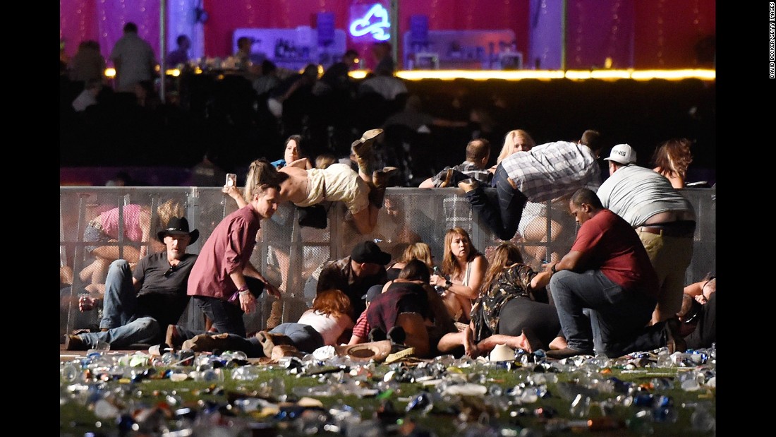 People scramble for shelter at the Route 91 Harvest country music festival. The shooter&#39;s motive remains a mystery.