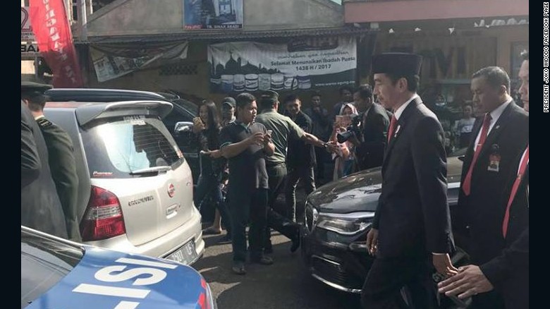 Indonesian President Widodo walks to event after being stuck in major traffic jam.