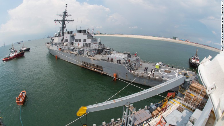 The guided-missile destroyer USS John S. McCain prepares to load aboard the heavy lift transport M/V Treasure off Singapore.
