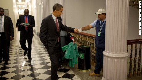 President Barack Obama fist-bumps custodian Lawrence Lipscomb in the Eisenhower Executive Office Building following the opening session of the White House Forum on Jobs and Economic Growth, December 3, 2009.