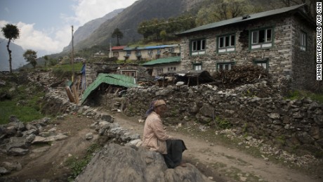 KHUMJUNG DISTRICT, NEPAL | 2015-05-04 | An old woman sits in front of her destructed house in Kyongma village, that was hit badly by the earthquake.