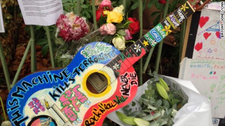 Makeshift memorials have popped up outside the Bataclan to honor those killed and wounded inside.