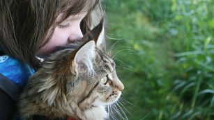 Portrait of a 6-year-old artist with autism and her therapy cat