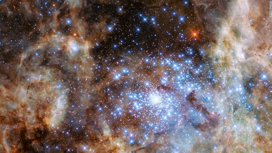 This image shows the central region of the Tarantula Nebula in the Large Magellanic Cloud. The young and dense star cluster R136, which contains hundreds of massive stars, is visible in the lower right of the image taken by the Hubble Space Telescope.