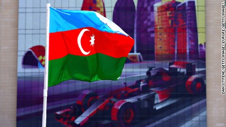 BAKU, AZERBAIJAN - JUNE 16: The Azerbaijan flag flies in front of a building with an F1 car graphic on during previews ahead of the European Formula One Grand Prix at Baku City Circuit on June 16, 2016 in Baku, Azerbaijan.  (Photo by Dan Istitene/Getty Images,)