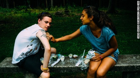 Kyle Maddison shows his friend (name needed, French camper) a tattoo he got in remembrance of his father, who died on 9/11. Their friendship grew out of their participation in Tuesday&#39;s Child.