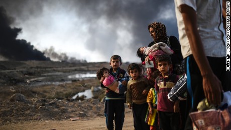 Iraqi families displaced by the ongoing operation to retake the city of Mosul from ISIS are seen near Qayyarah, south of the city, on October 29, 2016.