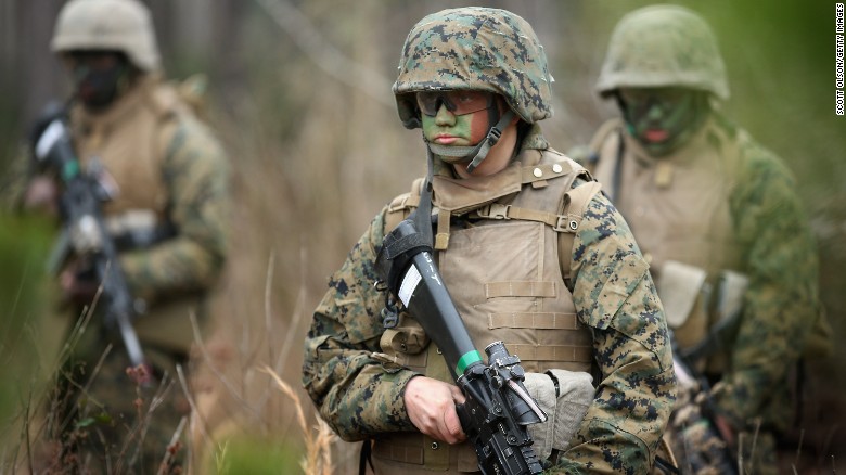 Pfc. Tiernie Gayle, center, trains with male and female Marines at Camp Lejeune, North Carolina. 