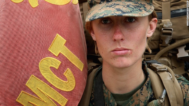 Pfc. Tiffany Mash leads a company of Marines carrying 55-pound packs at the start of a 10-kilometer training march in 2013 at Camp Lejeune, North Carolina. 