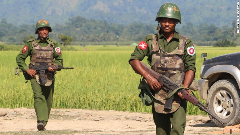In this photograph taken on October 21, 2016, armed Myanmar army soldiers patrol a village in Maungdaw located in Rakhine State