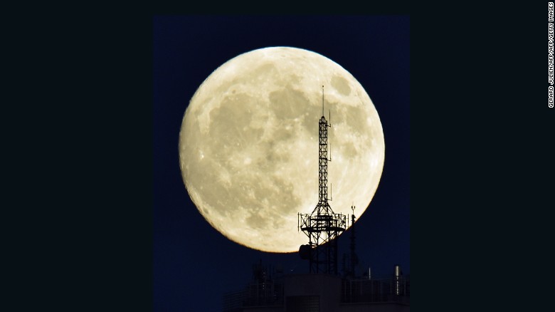 The moon rises over a building in Madrid on November 13, 2016, on the eve of the &quot;supermoon.&quot;
 