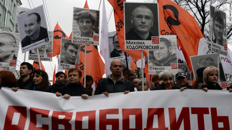 Thousands of Russians carry placards of political prisoners including Khodorkovsky and a banner reading &quot;Freedom!&quot; during an opposition rally in Moscow in 2013. 