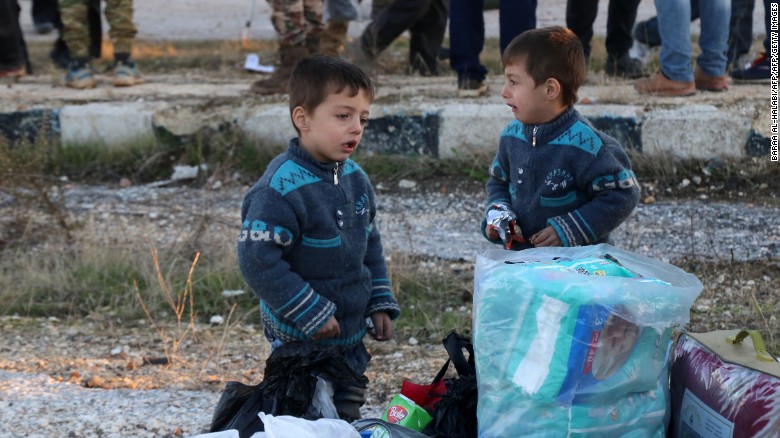 Syrian children evacuated from rebel-held areas in the embattled city of Aleppo arrive in the opposition-controlled Khan al-Aassal region on December 15, 2016, on the first stop on their trip.