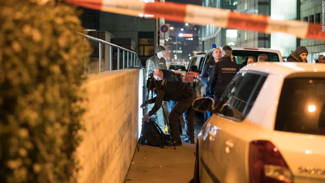 Policemen secure the area as the forensic team work, in front of the Islamic center, in Zurich, Monday, Dec. 19, 2016. A Zurich police official says a gunman has injured several people in Switzerland&#39;s largest city. The official said police were swarming to the scene in pursuit of the gunman who remains at large. (Ennio Leanza/Keystone via AP)