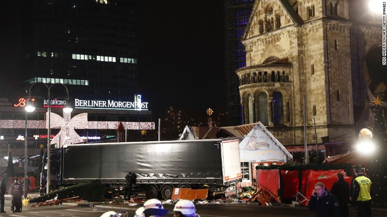 Policemen stand next to a truck that crashed into a Christmas market in Berlin.
