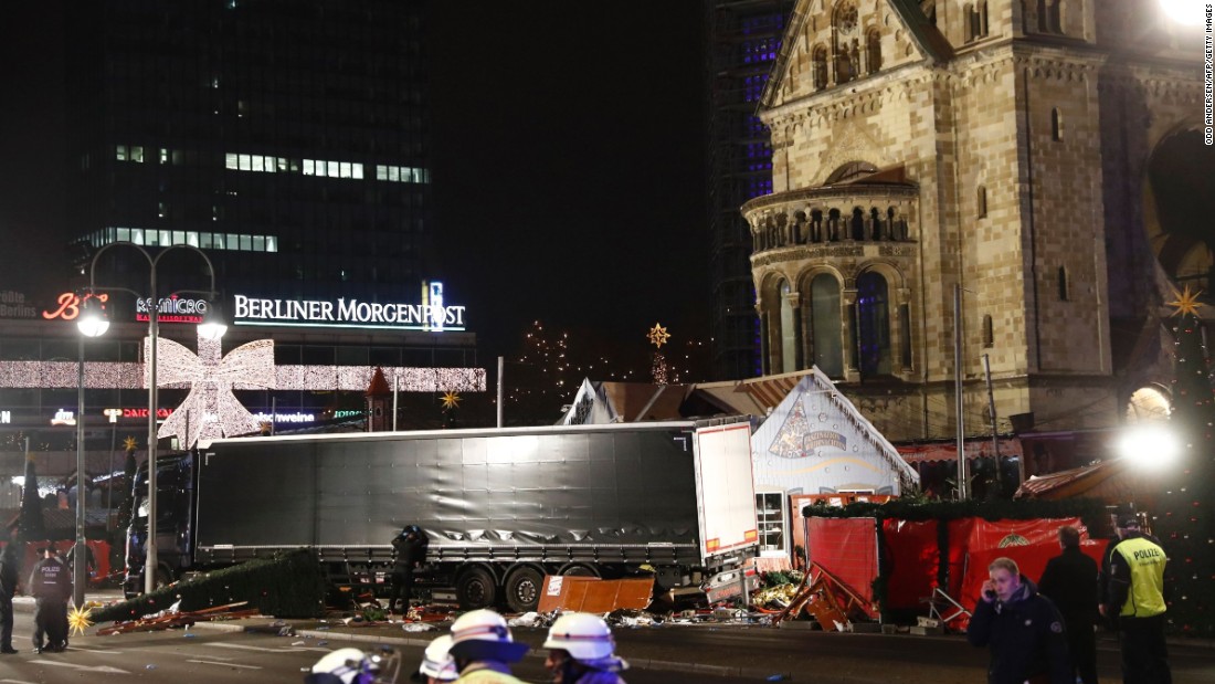 Policemen stand next to a truck that crashed into a Christmas market in Berlin, on December 19, 2016 killing at least one person and injuring at least 50 people.
Ambulances and police rushed to the scene after the driver drove up the pavement of the market in a central square popular with tourists less than a week before Christmas, in a scene reminiscent of the deadly truck attack in Nice.