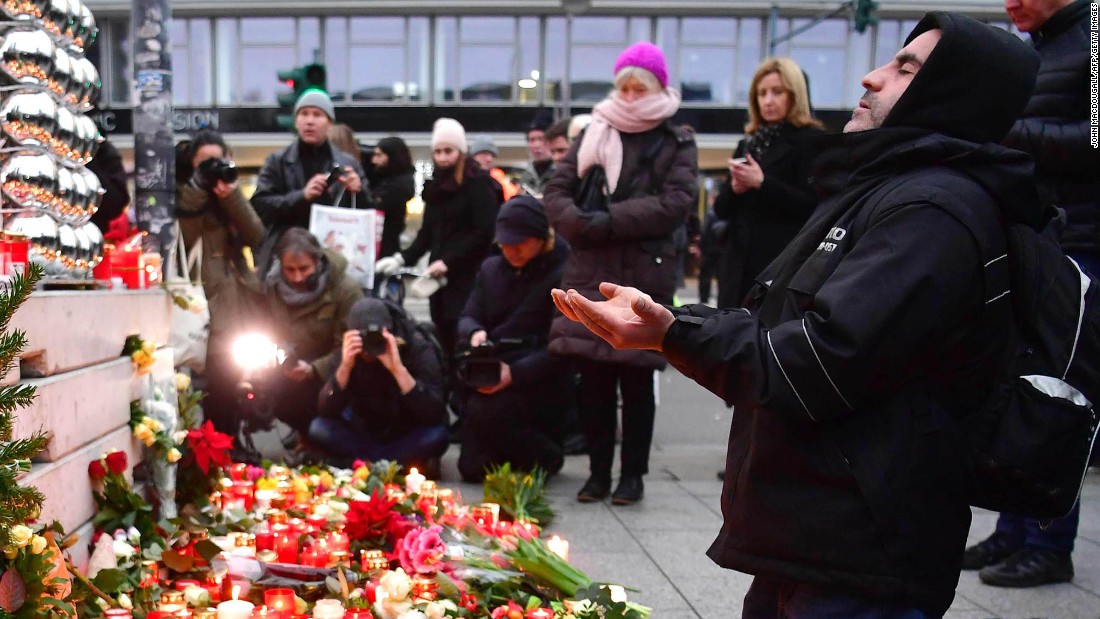 A Muslim mam prays at a makeshift memorial for the attack victims, on December 20, 2016 in front of the Kaiser-Wilhelm-Gedaechtniskirche (Kaiser Wilhelm Memorial Church) in Berlin, where a truck crashed into a Christmas market.
Twelve people were killed and almost 50 wounded, 18 seriously, when the lorry tore through the crowd on December 19, 2016, smashing wooden stalls and crushing victims, in scenes reminiscent of July&#39;s deadly attack in the French Riviera city of Nice. / AFP PHOTO / John MACDOUGALLJOHN MACDOUGALL/AFP/Getty Images