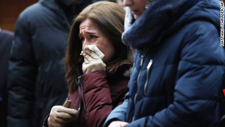 People react near the crime scene in Berlin, Germany, Tuesday, Dec. 20, 2016, the day after a truck ran into a crowded Christmas market and killed several people. (AP Photo/Matthias Schrader)