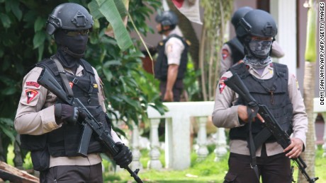 CORRECTION - Armed police secure a house after a firefight erupted as alleged militants had opened fire at officers in South Tangerang, 25 kilometres (15 miles) outside the capital Jakarta, on December 21, 2016. 
Indonesian police have foiled plans for a Christmas suicide bombing after killing three suspected militants on December 21 and discovering a cache of bombs, authorities said.
 / AFP PHOTO / Demy SANJAYA / The erroneous mention[s] appearing in the metadata of this photo by Demy SANJAYA has been modified in AFP systems in the following manner: [South Tangerang] instead of [Jakarta] for the dateline. Please immediately remove the erroneous mention[s] from all your online services and delete it (them) from your servers. If you have been authorized by AFP to distribute it (them) to third parties, please ensure that the same actions are carried out by them. Failure to promptly comply with these instructions will entail liability on your part for any continued or post notification usage. Therefore we thank you very much for all your attention and prompt action. We are sorry for the inconvenience this notification may cause and remain at your disposal for any further information you may require.DEMY SANJAYA/AFP/Getty Images