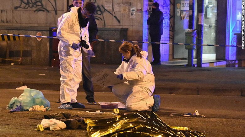 Italian forensics experts gather around the body of suspected Berlin truck attacker Anis Amri on Friday. 