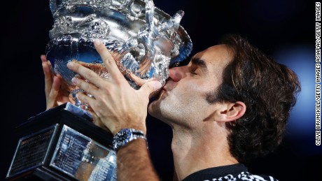 Roger Federer of Switzerland kisses the Norman Brookes Challenge Cup after winning the men&#39;s final match against Rafael Nadal 