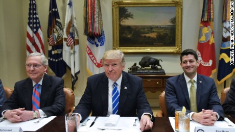 US President Donald Trump is seated for a a lunch with Republican Party House and Senate leadership, including Senate Majority Leader Mitch McConnell (L) and House Speaker Paul Ryan, in the Roosevelt Room of the White House in Washington, DC on March 1, 2017.