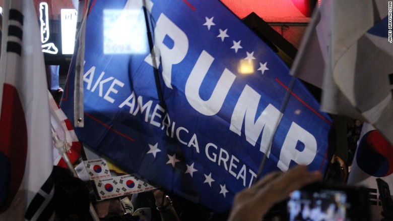 Park supporters wave a Donald Trump campaign flag. &quot;We want to make Korea great again,&quot; they said.