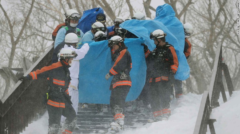 Firefighters carry a survivor from the site of an avalanche at Mount Nasu, Japan, on Monday.