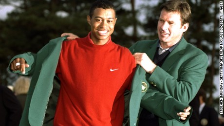 13 Apr 1997:  1996 US Masters winner Nick Faldo of Great Britain helps 1997 winner Tiger Woods of the USA put on the Green Jacket after Woods won the US Masters at Augusta, Georgia with a record low score of 18 under par. \ Mandatory Credit: Stephen Munday /Allsport