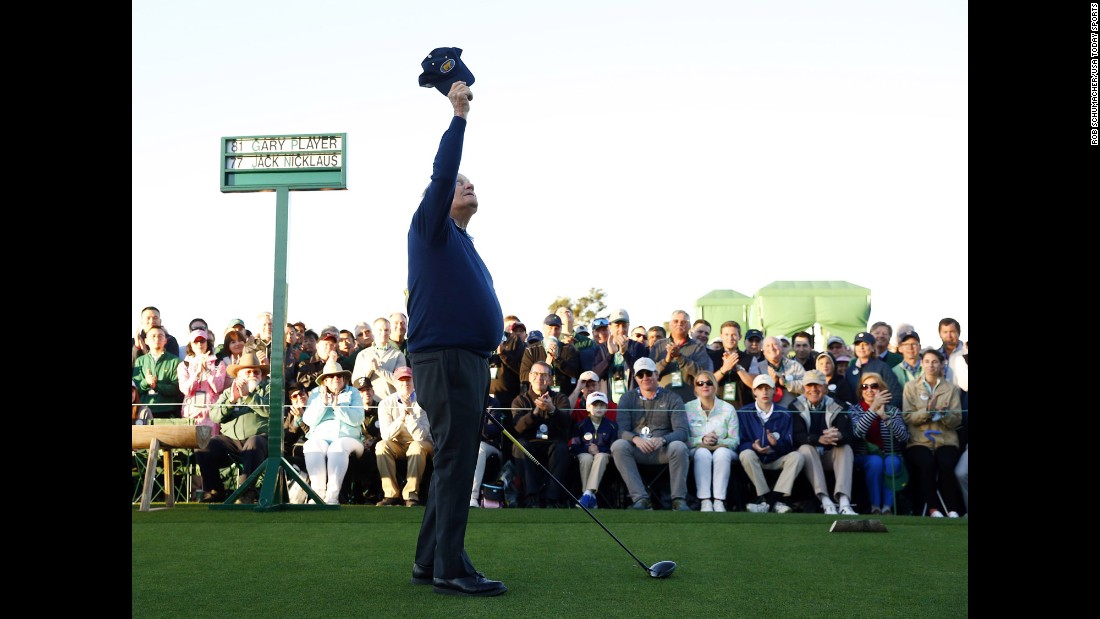 Jack Nicklaus raises his cap to the sky, honoring Palmer before hitting a ceremonial tee shot.