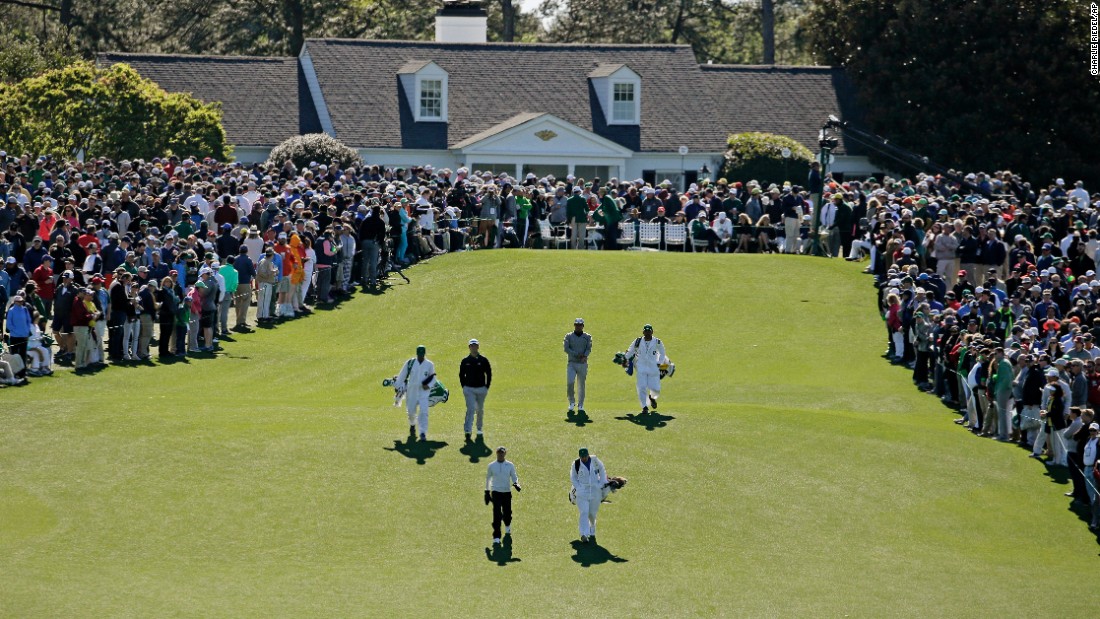 Golfers walk up to the first fairway on Friday.