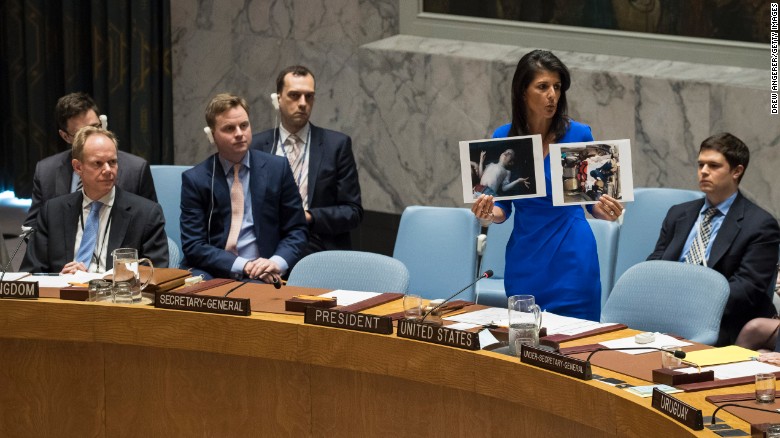 UN Ambassador Nikki Haley holds up photos of victims of the Syrian chemical attack during a Security Council meeting.