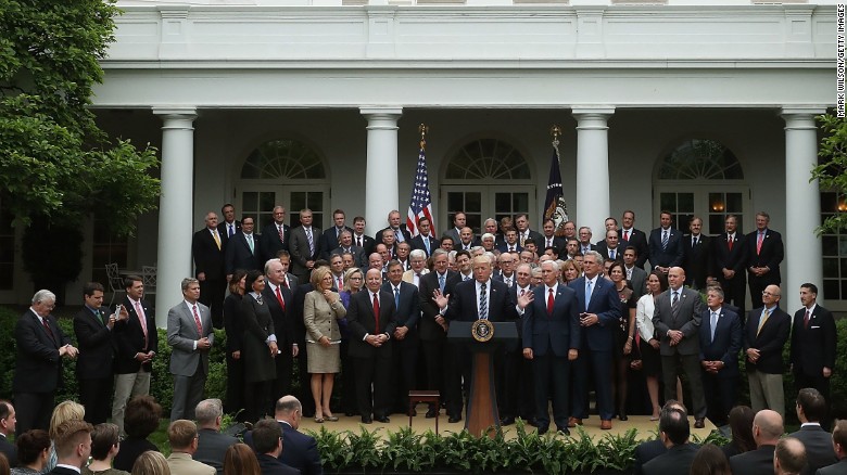 President Donald Trump speaks while flanked by House Republicans after they passed legislation last week aimed at repealing and replacing Obamacare.