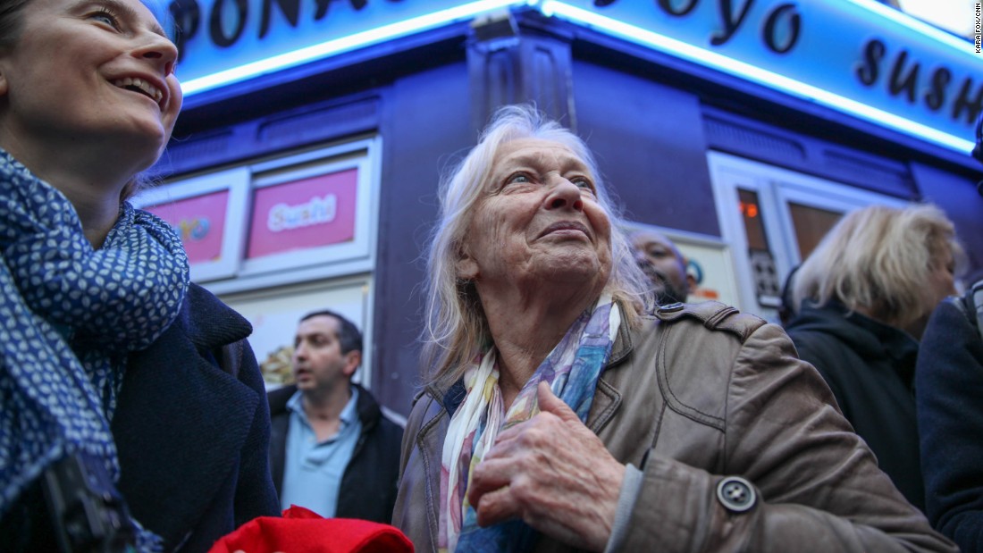 Sabine Gruhier (L), of Paris&#39; 15th district, gathers with her neighbors on the street outside Macron&#39;s headquarters moments before the polls close on election day.