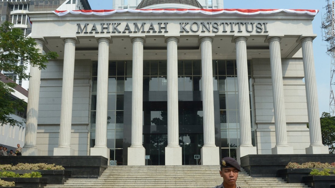 An Indonesian policeman stands guard outside the Constitutional Court in Jakarta in August 2014.