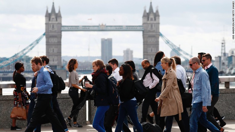 Commuters walk across London Bridge on Monday after it partially re-opened following Saturday&#39;s attack.