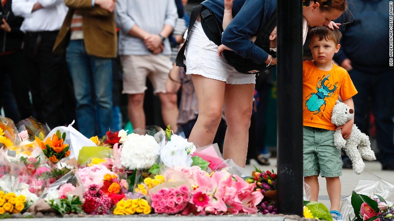 A woman and child lay flowers near London Bridge on Monday to remember the victims of the attack.