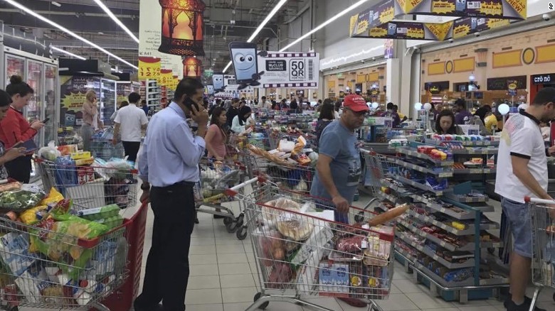 Shoppers stock up on supplies at a supermarket in Doha, Qatar on Monday, June 5, 2017.