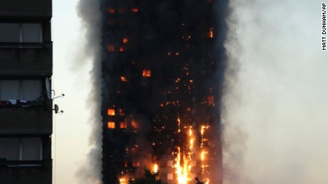 Smoke and flames rise from the Grenfell Tower building on fire in London.