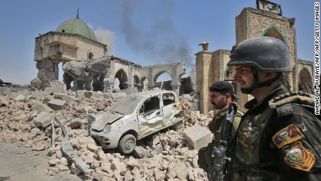 Members of the Iraqi Counter-Terrorism Services (CTS) walk past the destroyed Al-Nuri Mosque in the Old City of Mosul, as they continue their offensive to retake the city from Islamic State (IS) group jihadists on June 30, 2017.
IS blew up the mosque and the famed Al-Hadba (hunchback) leaning minaret on June 21 as Iraqi forces closed in. / AFP PHOTO / Ahmad al-Rubaye        (Photo credit should read AHMAD AL-RUBAYE/AFP/Getty Images)