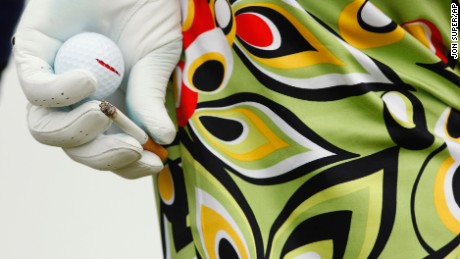 John Daly of the US holds a ball and cigarette during the second  round of the British Open Golf championship, at the Turnberry golf course, Scotland, Friday, July 17, 2009. 