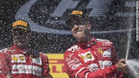 Sebastian Vettel celebrates on the podium after a Ferrari one-two in Hungary.