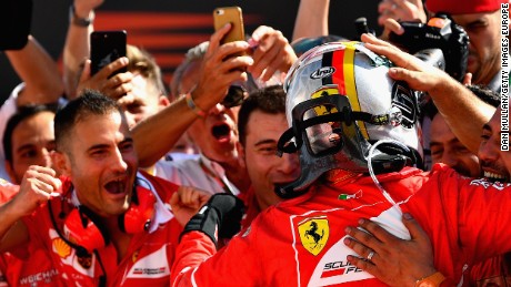  Sebastian Vettel celebrates his Hungary GP win in parc ferme with his Ferrari team.