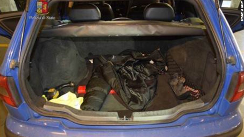 A police photo shows a large bag in the back of a car.