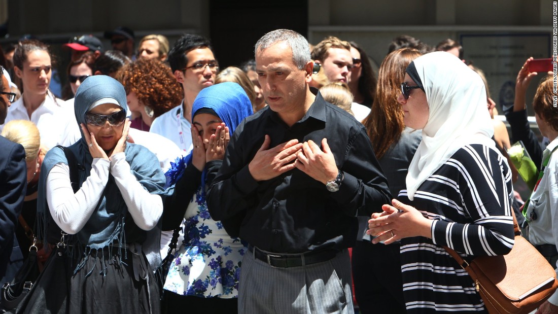 Muslim community leader Dr Jamal Rifi and family members lay a wreath at the makeshift memorial at Martin Place after the 2014 shootings at the Lindt coffee shop in Sydney&#39;s Martin Place. Sydney Australia.