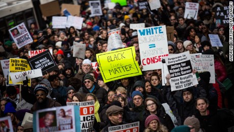 NEW YORK, NY - DECEMBER 13:  People march in the National March Against Police Violence, which was organized by National Action Network, through the streets of Manhattan on December 13, 2014 in New York City. The march coincided with a march in Washington D.C. and comes on the heels of two grand jury decisions not to indict white police officers in the deaths of two unarmed black men.  (Photo by Andrew Burton/Getty Images)